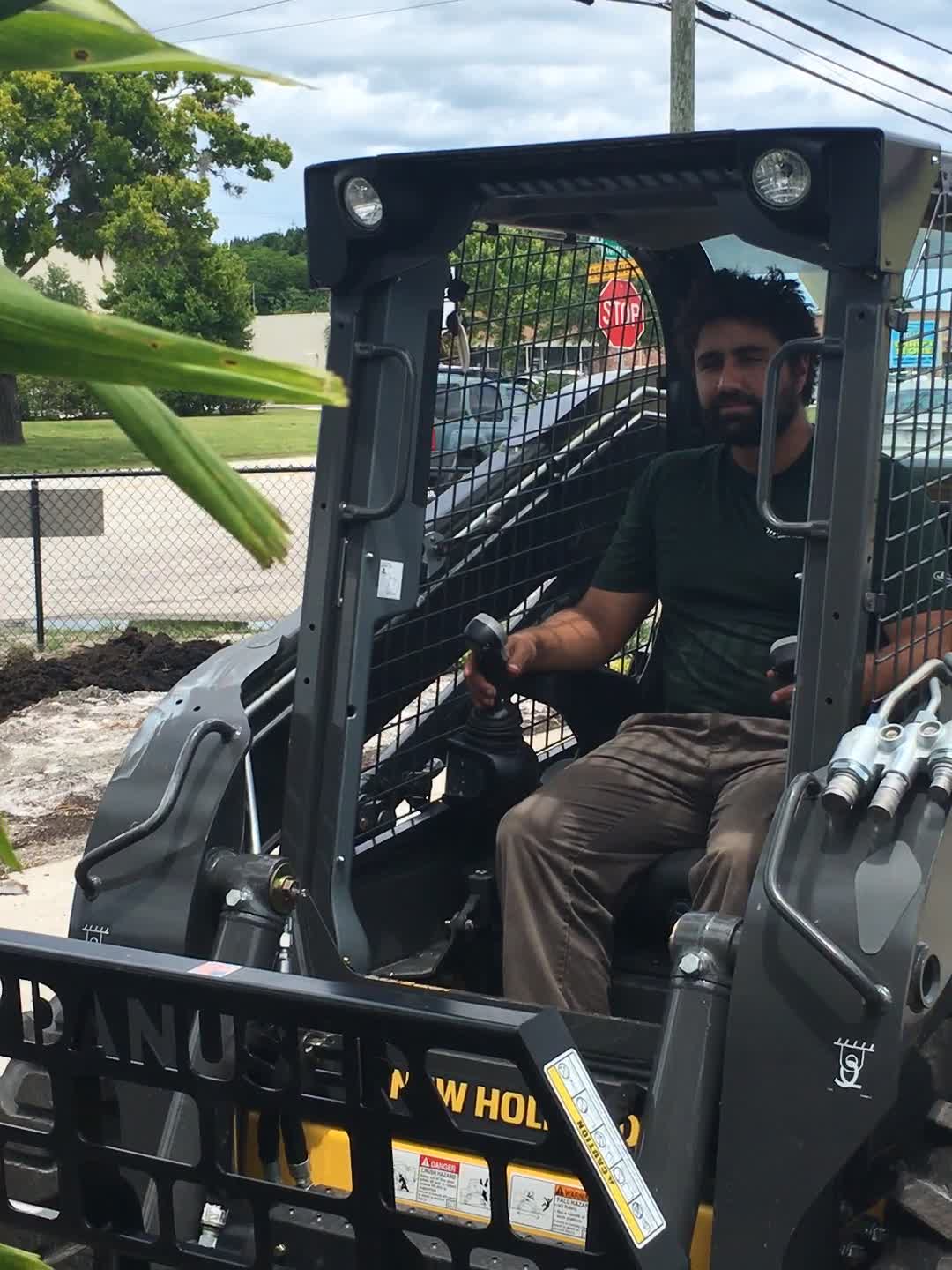 Brian Scalise operating a skid steer on a Oakmont Springs job site